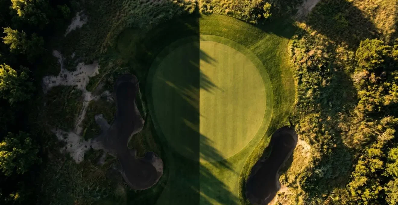 Aerial view of golf green showing safe landing zones and danger areas around pin positions