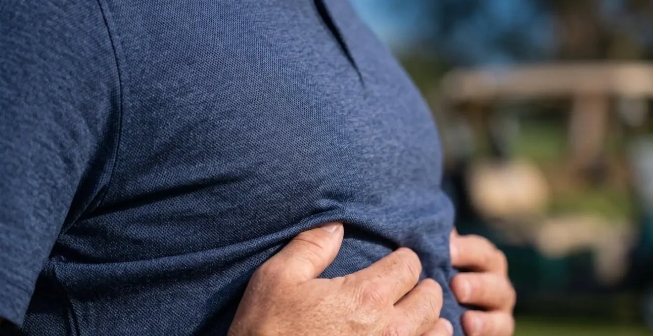 Extreme close-up of golfer's chest and hands during breathing exercise