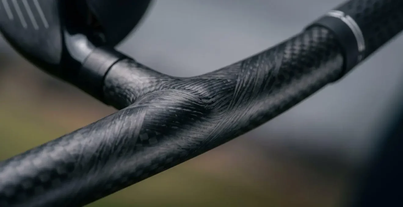 Macro close-up of golf club shaft at impact showing flex characteristics and dynamic lie angle changes